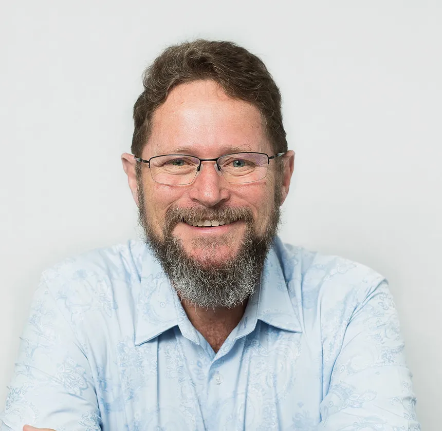 Headshot of Chris, smiling man in light blue shirt